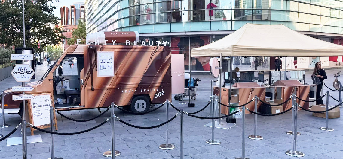One of FENTY Beauty's experiential events, featuring a US postal van and foundation stand in a city centre.