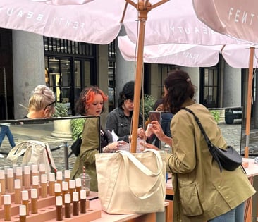 A group of women sample Fenty's foundations in Covent Garden for an experiential campaign.