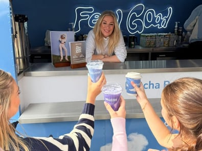A Hollister staff member hands out macha lattes for their experiential event campaign.