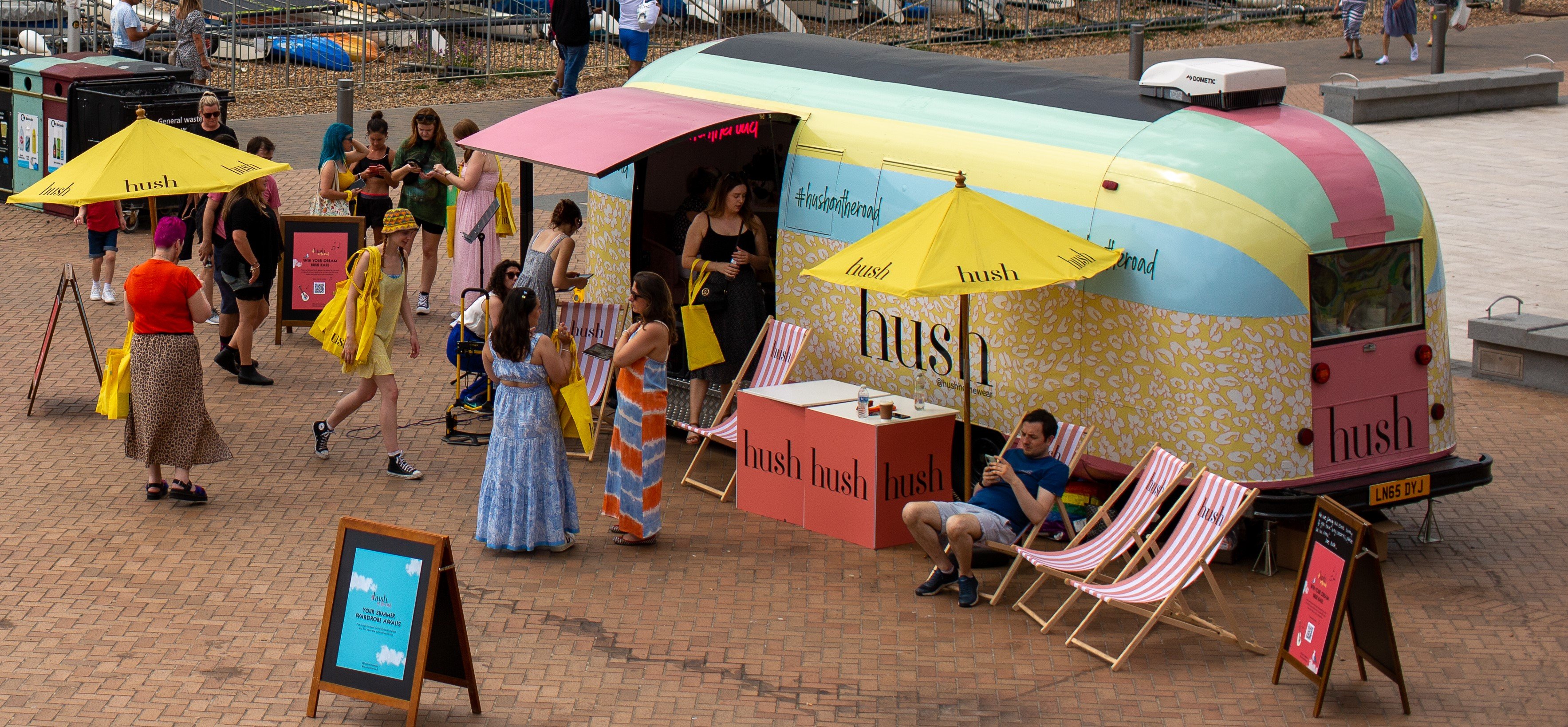 The HUSH Airstream with guests nearby.