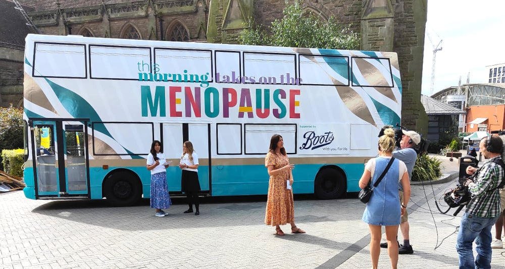 A promotional content image for the Menopause bus in front of a church for This Morning.