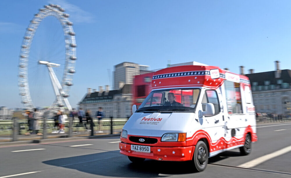 An ice cream van drives past the London Eye