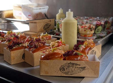 Burger Lobster samples with sauces and branded containers, ready for a live sampling campaign.
