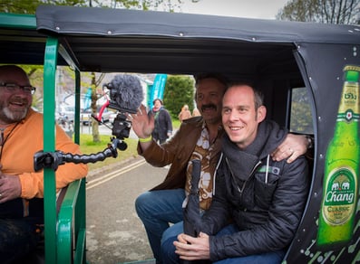 Guests smile inside the Chang Beer tuk tuk