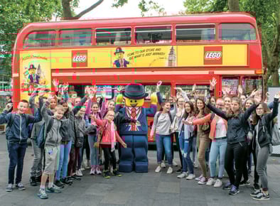 LEGO's London Routemaster bus. Bright red with a group of children.