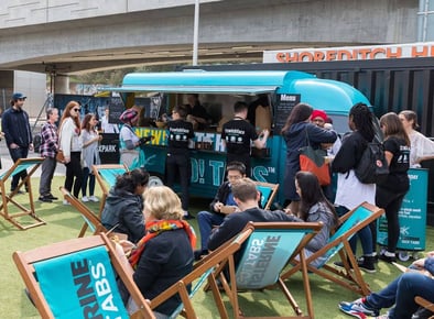 The Listerine food truck hire, with many people sat around it and enjoying a promotional event.