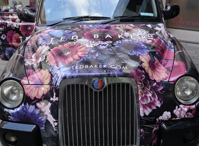 The front of the branded Ted Baker black taxi cab.
