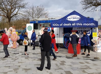 The Tesco centenary exhibition bus, with guests around during the event