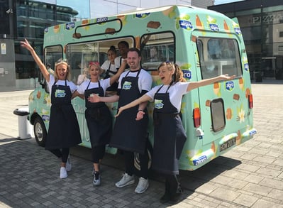 Staff pose with Alpro's ice cream sampling event van.