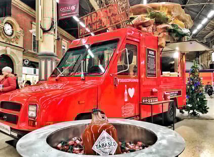 The red Tabasco Utilimaster in a train station, with a 3D roof prop.