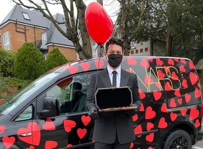 A model poses with the NARS love heart beauty brand vehicle.