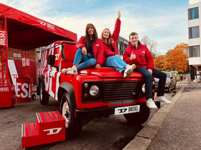 DIESEL staff on one of Promohire's Land Rover Defenders, branded for a promotional campaign.