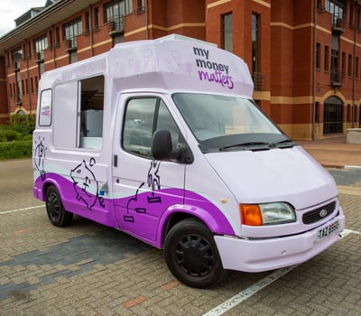 A front view of the My Money Matters van, parked for a live awareness campaign.