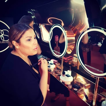 A woman tries the make-up beauty samples in the NARS beauty experience Airstream.