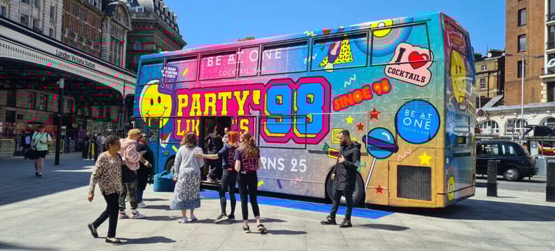 The double-decker party bus, on location at Victoria station, as per the campaign plan.