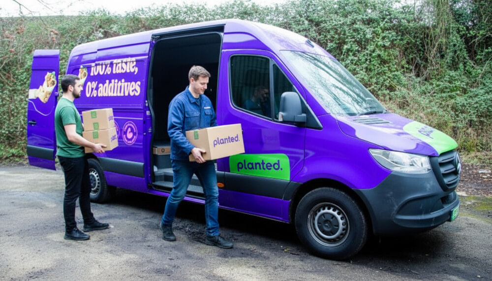 Staff move food and beverages from a mobile food van.