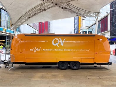 QV Skincare's large promotion, using a bright vintage Airstream