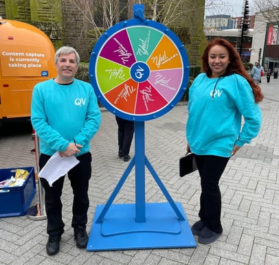 Brand ambassadors pose with the QV Skincare Airstream, with a spin-to-win game