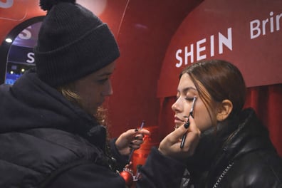 A young woman gets a makeover at SHEIN's seasonal Christmas event.