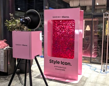 A pink photobooth and camera, event props for a live promotional campaign.