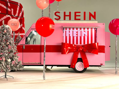 A pink Utilimaster post van, with a bow and roof prop for one of SHEIN's festive brand activations and events.