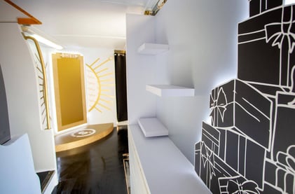 Inside SHEIN's beauty bus, with a white glow.