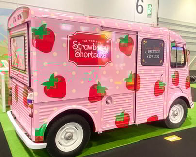 A side view of the Strawberry Shortcake promotional H-Van, as part of a brand awareness campaign at Excel London..