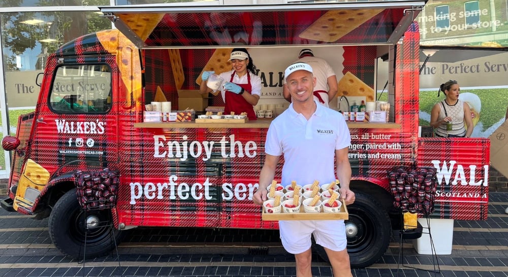 A branded van for a product sampling campaign for Walkers, with a man dressed as a tennis player with free samples available.
