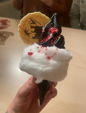 The custom Witcher ice cream with black soft serve and a wolf medallion wafer.