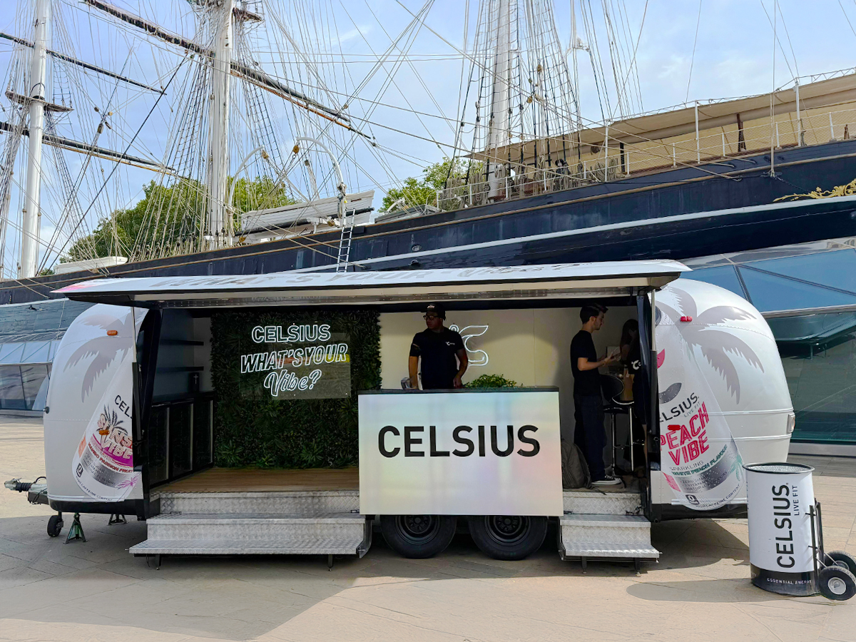 An image of a branded Airstream, with the hatch open at the dock. An immersive space idea for experiential events and campaigns.