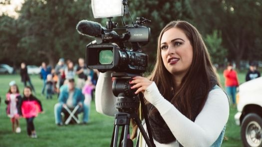 A woman taking video as part of promotional campaign support services
