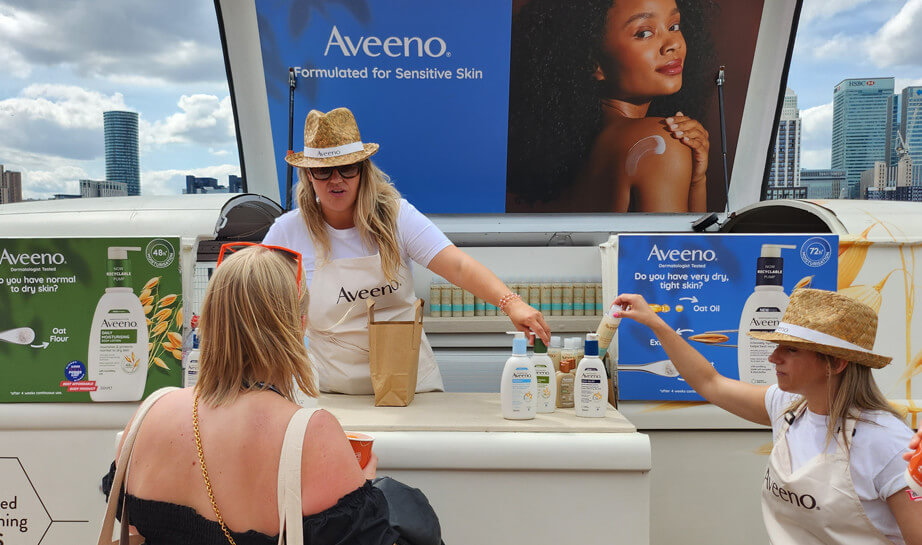 Staff hand out samples in London during one of Aveeno's skincare campaigns.