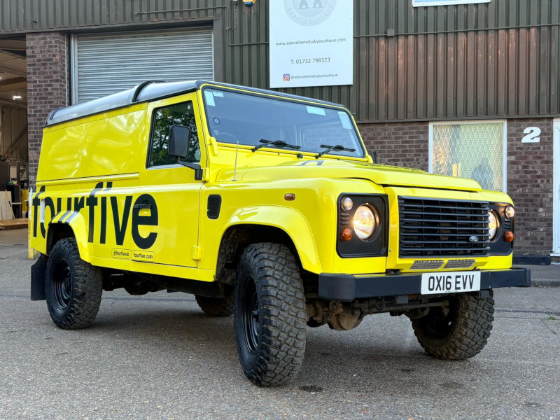 A custom Land Rover Defender - branded in yellow and built with a hydration system for a live brand activation or promotional campaign.