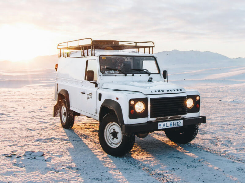 An image of a white Land Rover Defender, a classic model with a rich history.