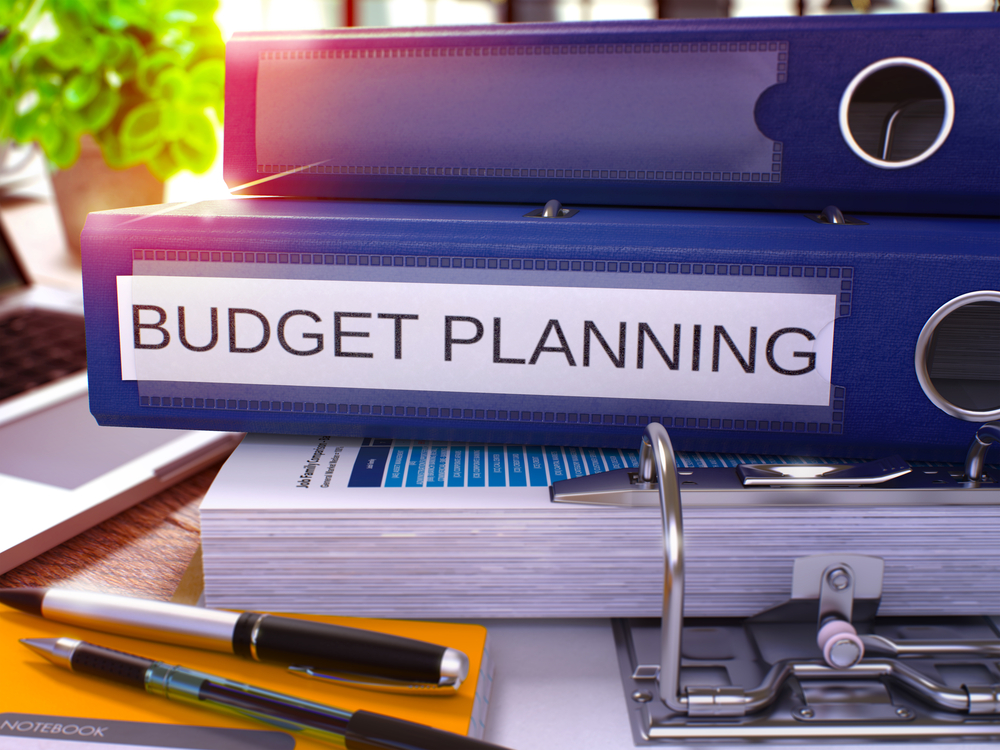 A folder that says 'budget planning, for someone creating their promotional vehicle budget.