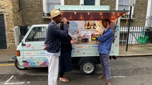 Doorstep promotional campaign - Couple sampling wine from Piaggio Ape wine bar