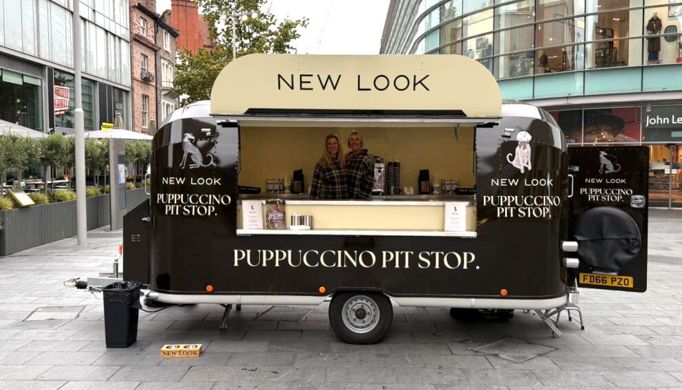 New Look's puppuccino drink sampling Airstream, with staff smiling inside.