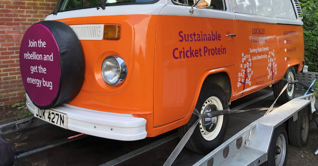 Orange and white pop up camper trailer